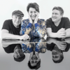 Auf dem Foto sind die Musiker. Eine Frau und zwei Männer.