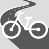 Zu sehen ist ein Fahrrad mit einer Straße im Hintergrund.