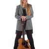 Zu sehen ist Bärbel Schmid vor einem weißen Hintergrund mit eine Gitarre in der Hand.